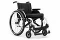 Lightweight manual wheelchair with silver and black frame on white background